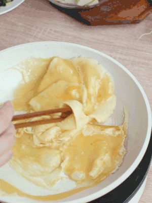 油6成熱時，下雞蛋液，邊緣凝固時翻拌成塊狀。